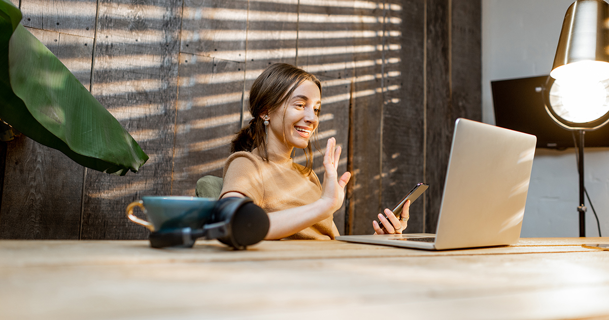 Young woman having a video call working on laptop from a home office